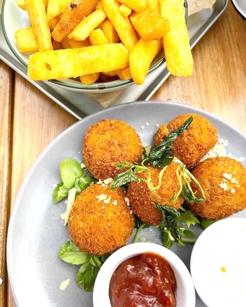 Fried croquettes and chips on a plate
