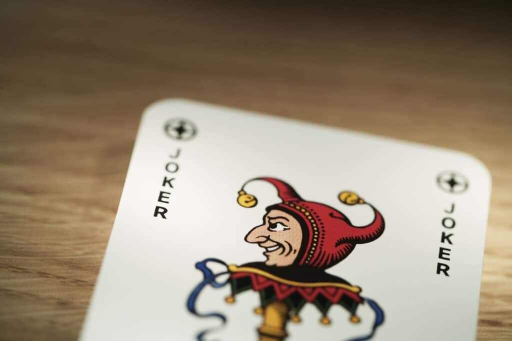 Joker playing card on timber